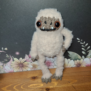 Milo is made with Lionbrand "feels like a dream" and "wool-ease"