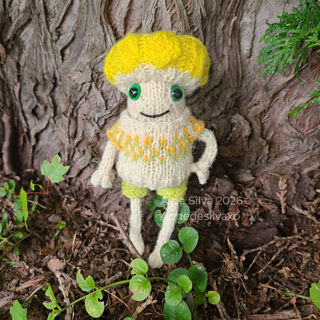 Micah the mushroom is wearing Froggy’s Linen Shorts, and the top from the Seed Stitch Overalls Set with some custom colorwork