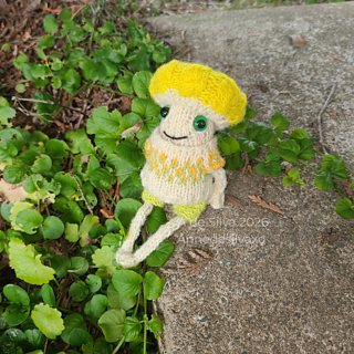 Micah the mushroom is wearing Froggy’s Linen Shorts, and the top from the Seed Stitch Overalls Set with some custom colorwork