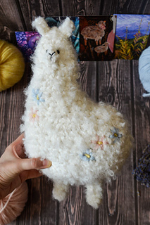 Big crochet soft toy - white plush alpaca with floral embroidery made of boucle yarn pdf pattern