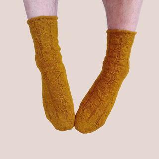 The same mustard-gold socks on dangling feet.