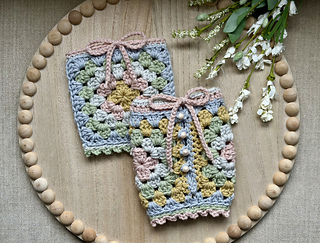 Pictured are both the open handle (top) and the attached handle (bottom) 40 oz cup cozies in Yarn Bee Soft & Sleek.