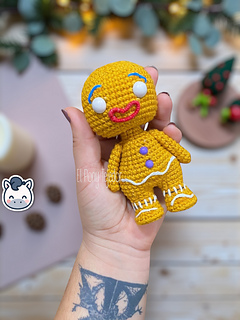 Amigurumi crochet free pattern of the Shrek Gingerbread Man with purple gumdrop buttons and white icing details.