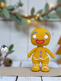 Amigurumi crochet free pattern of the Shrek Gingerbread Man with purple gumdrop buttons and white icing details.