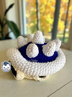 Crochet Amigurumi of the Blue Spiny Shell from Mario Kart made with soft blue and white yarn.