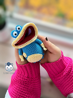 Handmade Globox amigurumi inspired by Rayman, a blue crochet character created with a detailed amigurumi pattern PDF, perfect for video game fans and geek plush lovers.