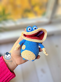 Handmade Globox amigurumi inspired by Rayman, a blue crochet character created with a detailed amigurumi pattern PDF, perfect for video game fans and geek plush lovers.