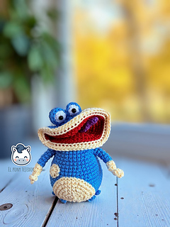 Handmade Globox amigurumi inspired by Rayman, a blue crochet character created with a detailed amigurumi pattern PDF, perfect for video game fans and geek plush lovers.