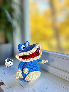 Handmade Globox amigurumi inspired by Rayman, a blue crochet character created with a detailed amigurumi pattern PDF, perfect for video game fans and geek plush lovers.