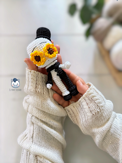 Handmade Art the Clown amigurumi inspired by Terrifier, featuring the iconic black-and-white costume, creepy facial details, and sunflower accessory in a detailed PDF crochet pattern for horror movie and amigurumi fans.