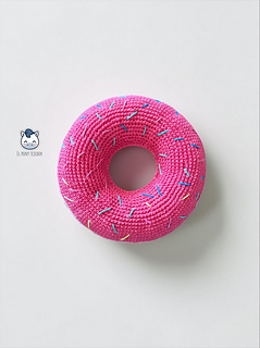 Crochet donut dog toy handmade with pink and beige yarn, a colorful DIY pet-friendly toy ideal for greyhounds and large dogs.