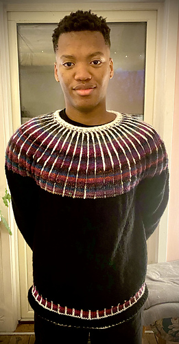 En test Strimma i akryl som sonen modellar för. Med Icord halsringning och i ett melerat garn