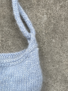 Horizontal stitches and the loop for the strap.