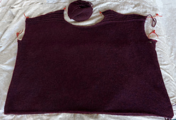 Finished the front. It's 35" wide x 27" long, just laid out, no stretching. Not sure why my garter stripes aren't the same on both sides -- starts with single ridge on right front.