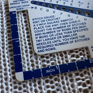 After blocking: 18 stitches x 30 rows. [Didn't photograph gauge before pinning with this "Knit Chek," but based on ruler measurement photos, it was about 26 stitches x 40 rows per four inches.]