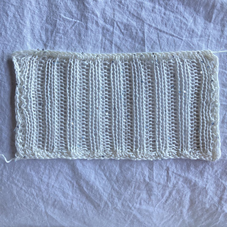 Warning to self to pin more carefully when blocking actual Shizen. This yarn takes a curl with sloppy pinning, as the vertical sides can attest. (In my defense, I was doing such arduous traction on the swatch that I couldn't budge it any further for neatness.)