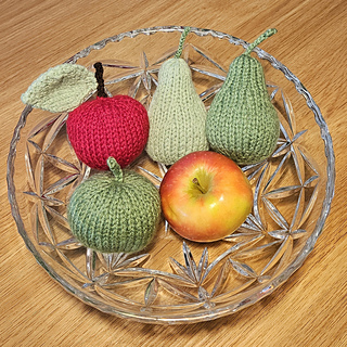 Knitted apple and knitted pears in knitted fruit bowl display