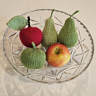 Knitted apple and knitted pears in knitted fruit bowl display
