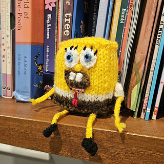 Knitted SpongeBob toy on bookshelf