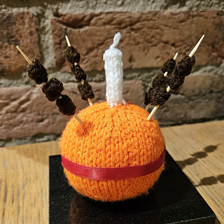 Knitted Christingle on a sideboard for Christmas Knitted Home decor