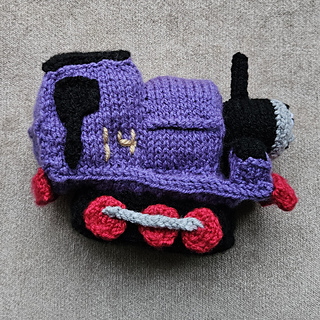 Charlie toy knitted train on a cushion