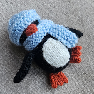 cute knitted penguin toy with hat and scarf