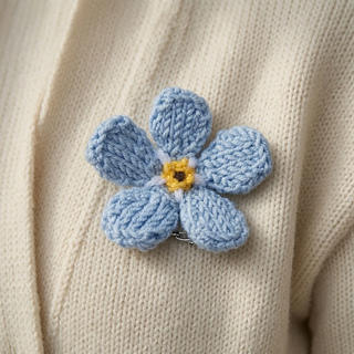 Knitted forget-me-not flower brooch