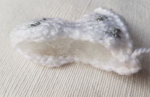 Sewing up little knitted angel