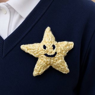 Knitted gold star with smiley face emboidery