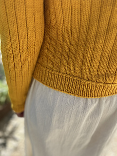 Lateral braid framing the ribbing.
