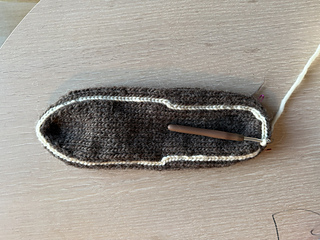 Crochet chain framing the sole.