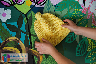 Bright yellow crochet beanie with textured stitch and pompom, soft DK yarn.