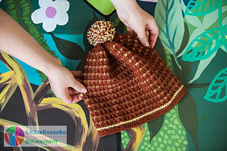 Cozy crochet beanie in warm brown with yellow accents, DK yarn, textured stitch and playful pompom, handmade slouchy hat.