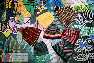 Seven colorful crochet hats in mosaic and striped patterns, featuring fitted and slouchy shapes with some topped by pom-poms.