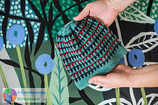 A crochet child’s beanie made with the mosaic overlay technique, creating a striped pattern.

