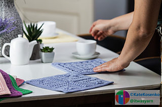 A crochet square made of Dk weight yarn with raised ridges and a textured stitch pattern across the block.