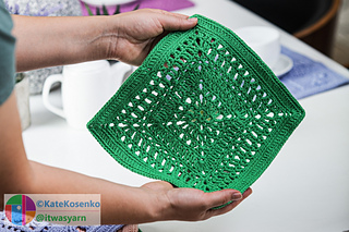 Close-up view of the lace pattern in the green crocheted "March" square.