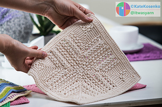 Detailed close-up showing the textured stitches of a yellow crocheted square, made from soft cotton yarn.