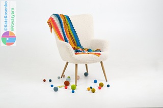 Crochet shawl draped over chair showing size, shape, and colorwork in modular pattern