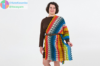 Front view of lace crochet shawl worn over one shoulder with belt, highlighting striped colorwork and shape