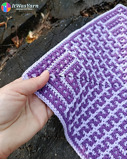Hand holding the corner of the Drift overlay mosaic crochet square.