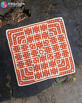 Ripple crochet square in cream and rust on a tree stump.