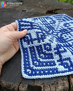 Hand holding a side of the Orbit crochet block.