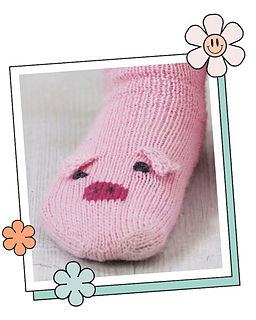 Close up of a knitted pig sock toe showing two pink ears, dark pink snout and embroidered eyes
