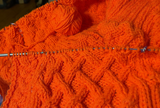 2023-03-16 Row 41 of yoke done. One bitty ball left + an almost full ball waiting to do the button bands and collar + 3 untouched balls left.  