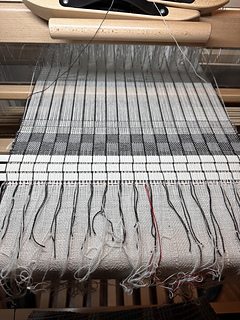 Red thread holding each supplemental thread in place. Took red thread out after had woven few inches.
