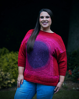 Amber has a 43"/107.5 cm bust and is wearing a size I, which has a finished bust of 48"/120 cm. Shown with 3/4 sleeves. Sizing up for more ease results in a longer garment, as shown. Uses Neighborhood Fiber Co Studio Sock.