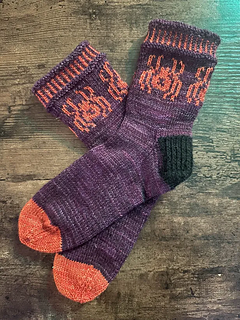 Madi's test knit, featuring spiders!