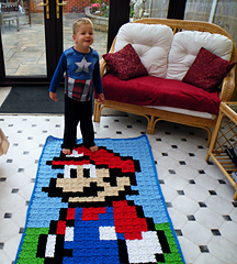 Oscar admiring his brother Sonny's new blanket.  He is looking forward to getting his Luigi blanket soon