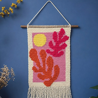 photo shows the real handmade crochet wall hanging displayed on a digitally edited background for presentation purposes 